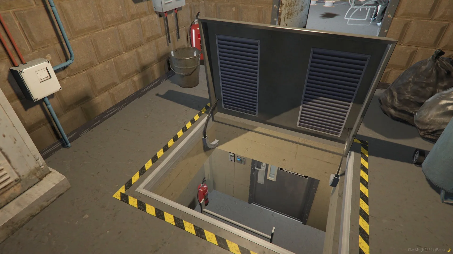 The hatch open in the floor of the technical room, with yellow and black hazard tape around it and the shaft below.